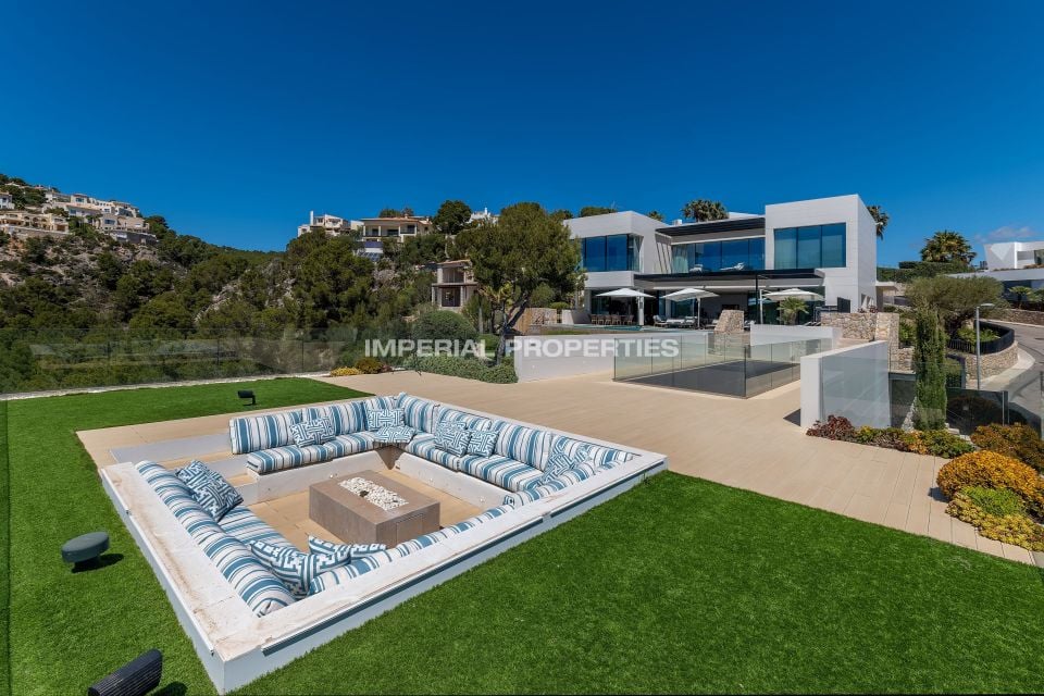 Modern white villa on a hillside above Port d'Andratx, with a sunken terrace and the Imperial Properties watermark
