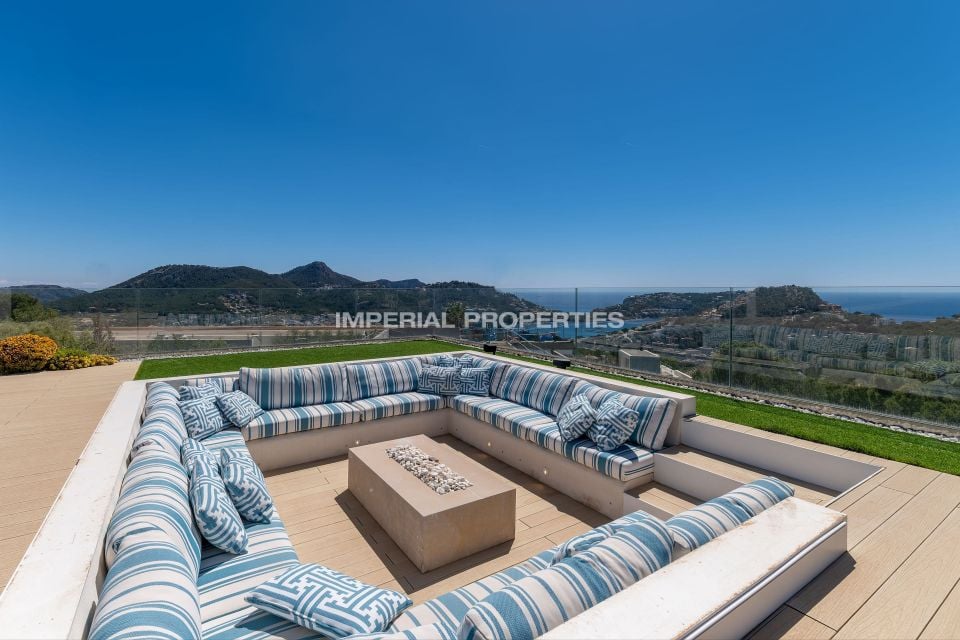 Sunken terrace seating looking over the bay, hills and open sea, Imperial Properties watermark